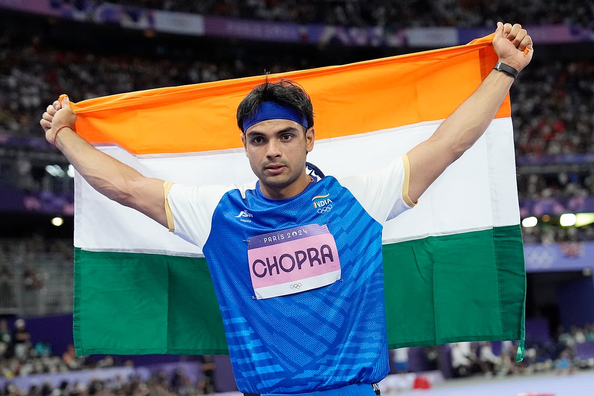 (AP Photo/Matthias Schrader) : Silver medalist, Neeraj Chopra, of India, celebrates after the men's javelin throw final at the 2024 Summer Olympics, Thursday, Aug. 8, 2024, in Saint-Denis, France. 
